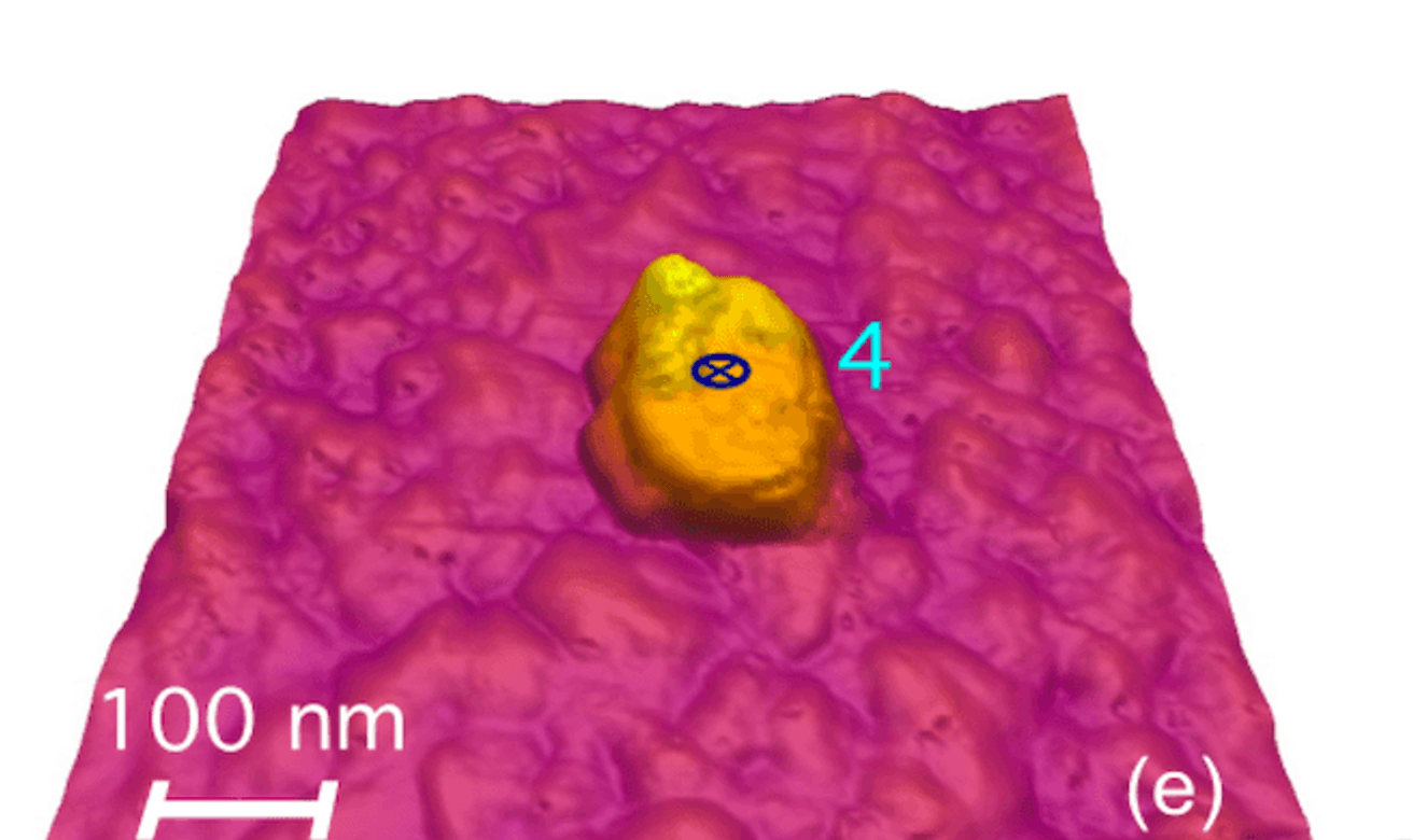 A single BiFeO₃ nanoparticle standing out on a scanned film surface, with a 100 nm scale bar